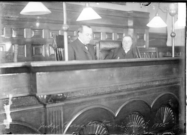 Judge George Kersten and Judge Green sitting at the judges' bench in court